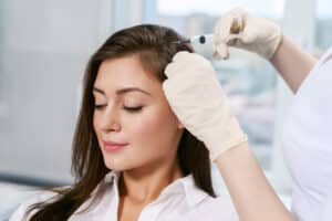 A woman getting PRP hair restoration injections in Plano, TX