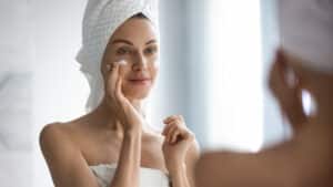 Woman putting on moisturizer after CO2 Laser Resurfacing in Plano, TX